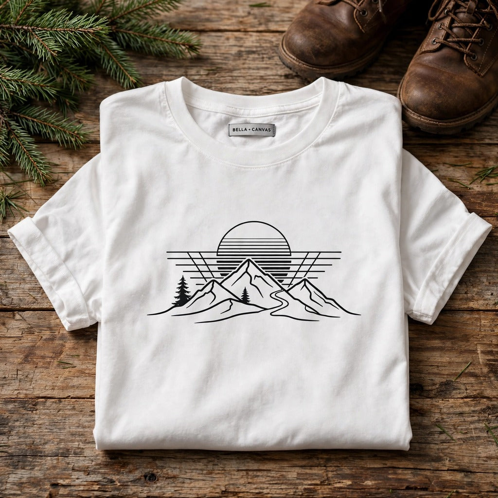 Retro sunset hiking tee flat lay on wood table with hiking boots - product detail