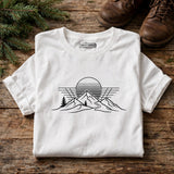 Retro sunset hiking tee flat lay on wood table with hiking boots - product detail
